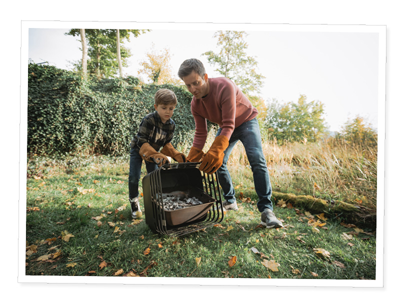 a father and son playing in the grass.