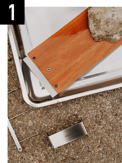 a piece of wood is being removed from the floor.