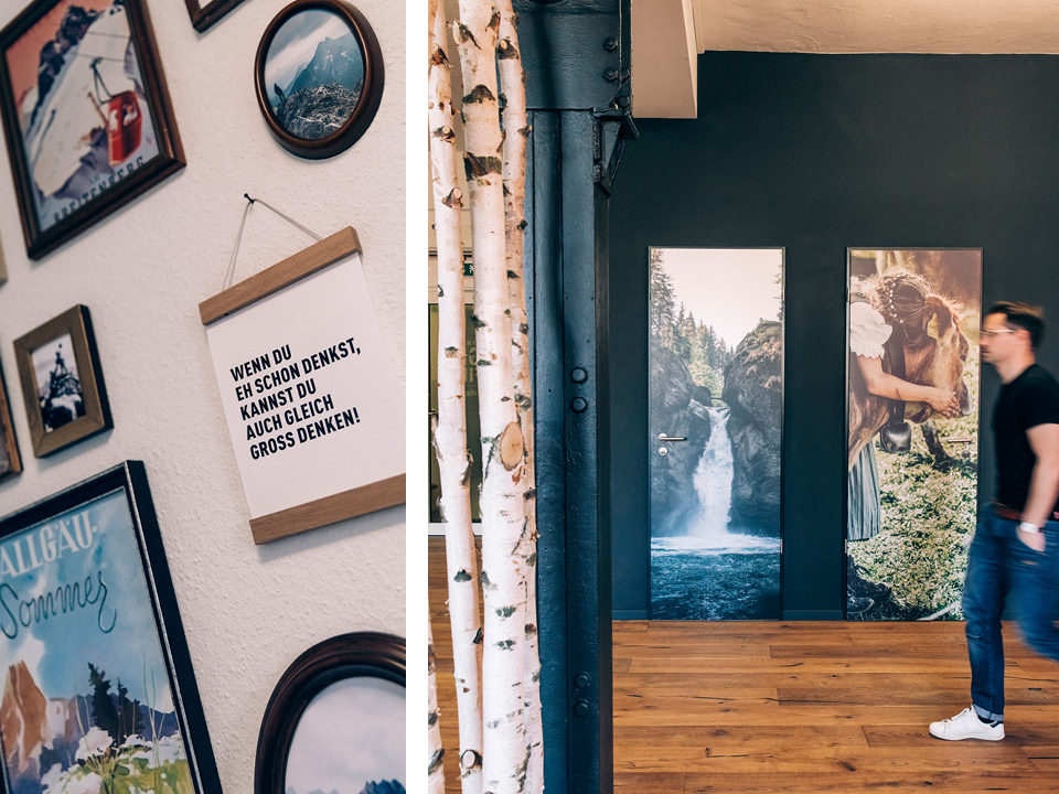a man standing in front of a wall with pictures on it.