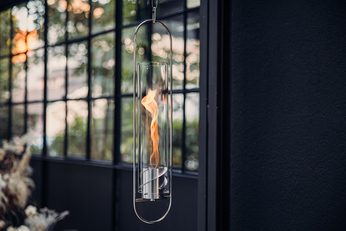 Scene showing a glass light hanging from a window, where the Spin 900 Hanging Fire stands out for its practical elegance.