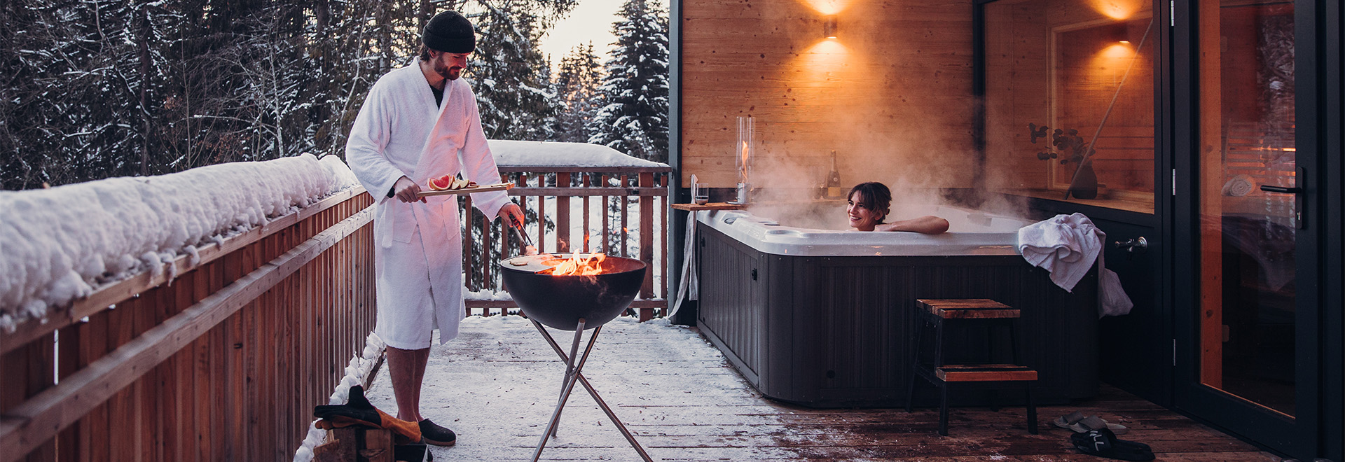 a man in a bath robe standing on a deck.