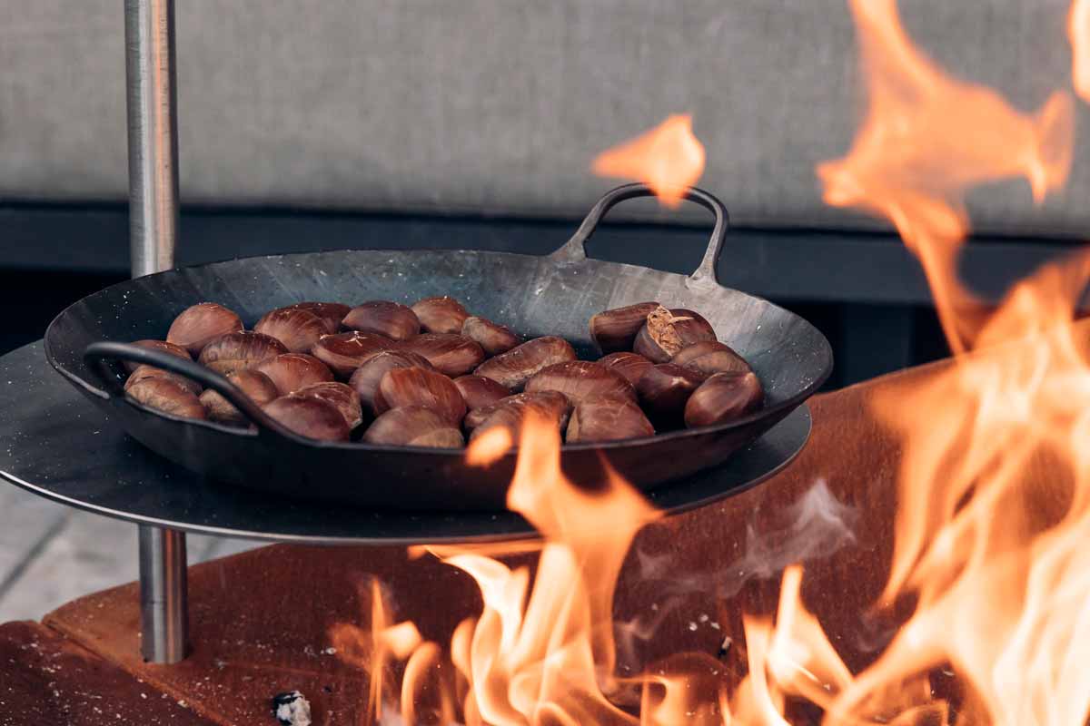 TRIPLE Montant 40 Scène montrant une poêle de saucisses sur un feu, où le TRIPLE Montant 40 se distingue par son élégance pratique.