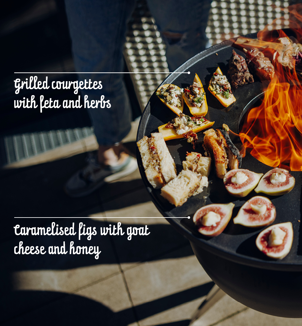 Grilling becomes an experience with the Moon Plancha, as the scene shows a dish being prepared outside.