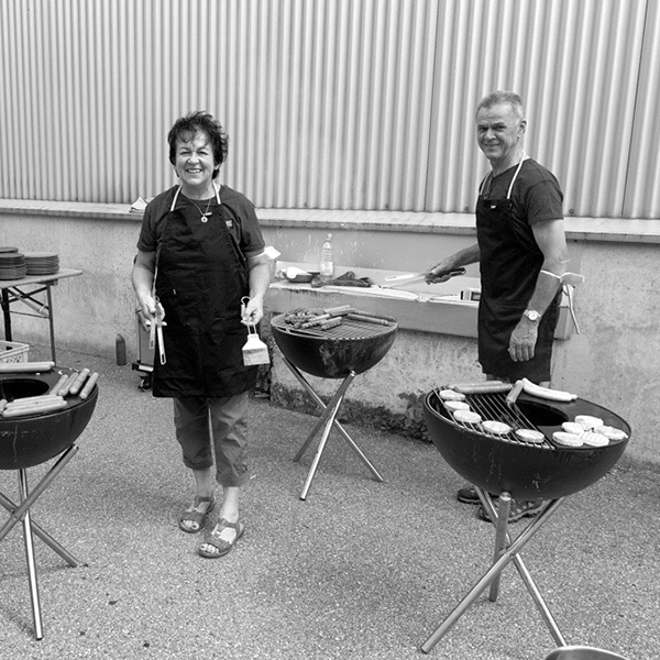 Zwei Frauen kochen auf einem Grill im Freien
