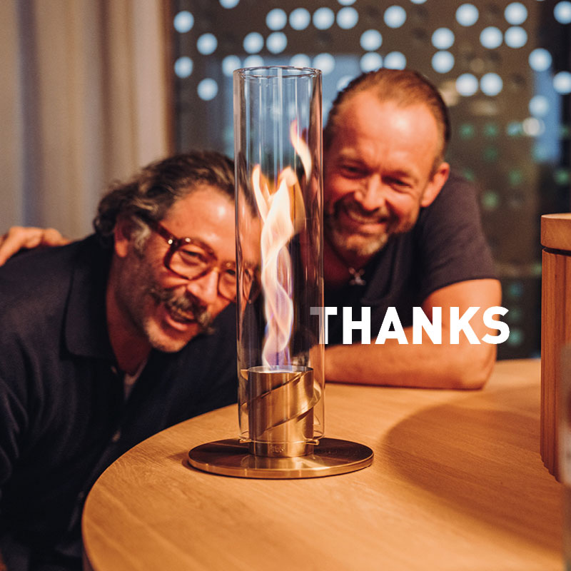 Experience two men sitting at a table with a Spin in front of them and the word "thanks"