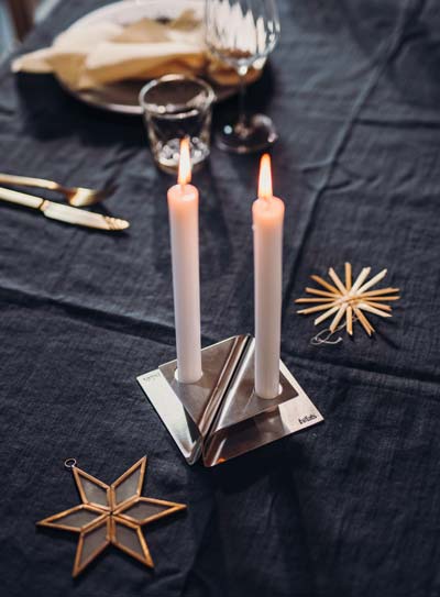 Scene showing a table with a candle , where the Square Candle stands out for its practical elegance.