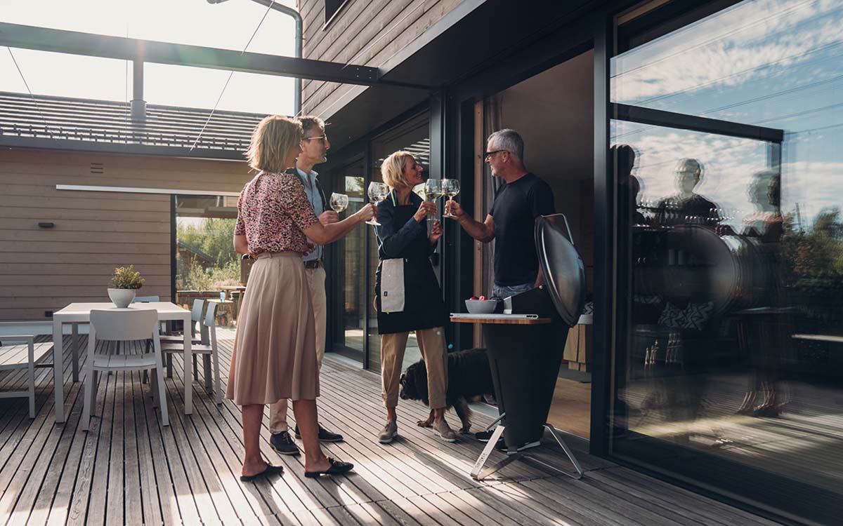 A view of a couple standing on a deck talking