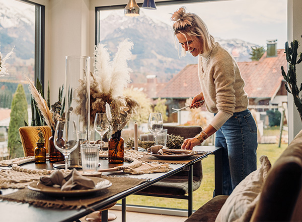 a woman standing in front of a window with a decorated table showing the spin tablefire