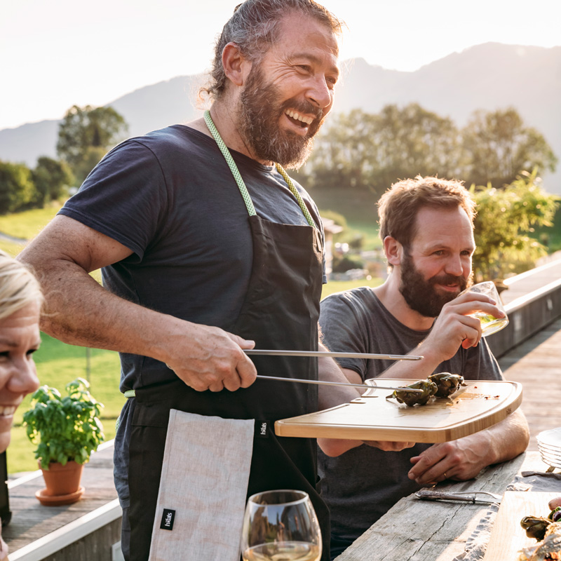Depicted here is a man holding a plate of food while another man holds a plate of food