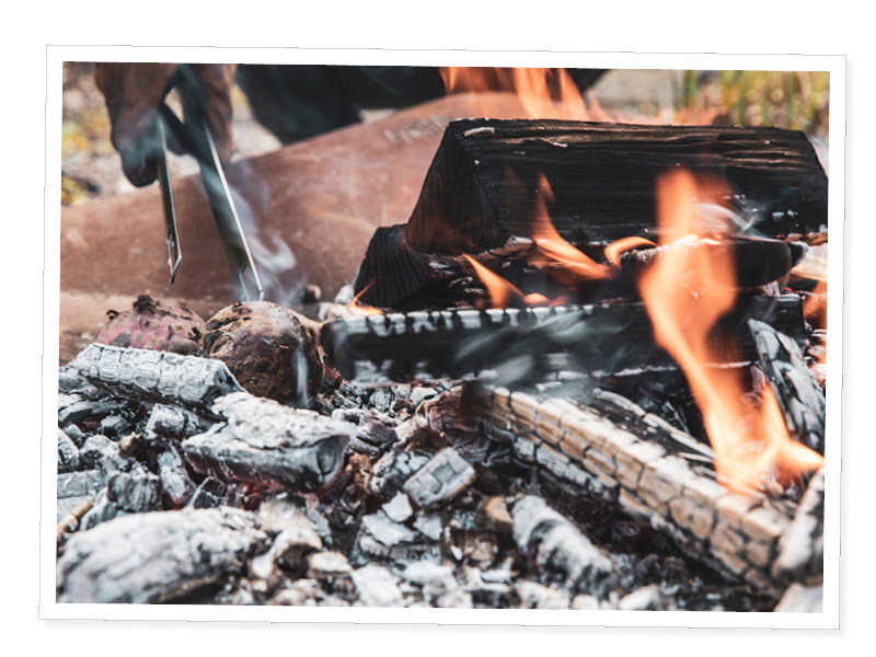 a fire with a person holding a knife.
