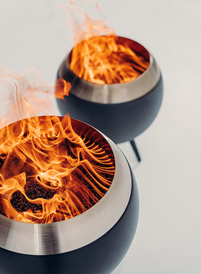 two metal bowls with fire inside without noticable smoke