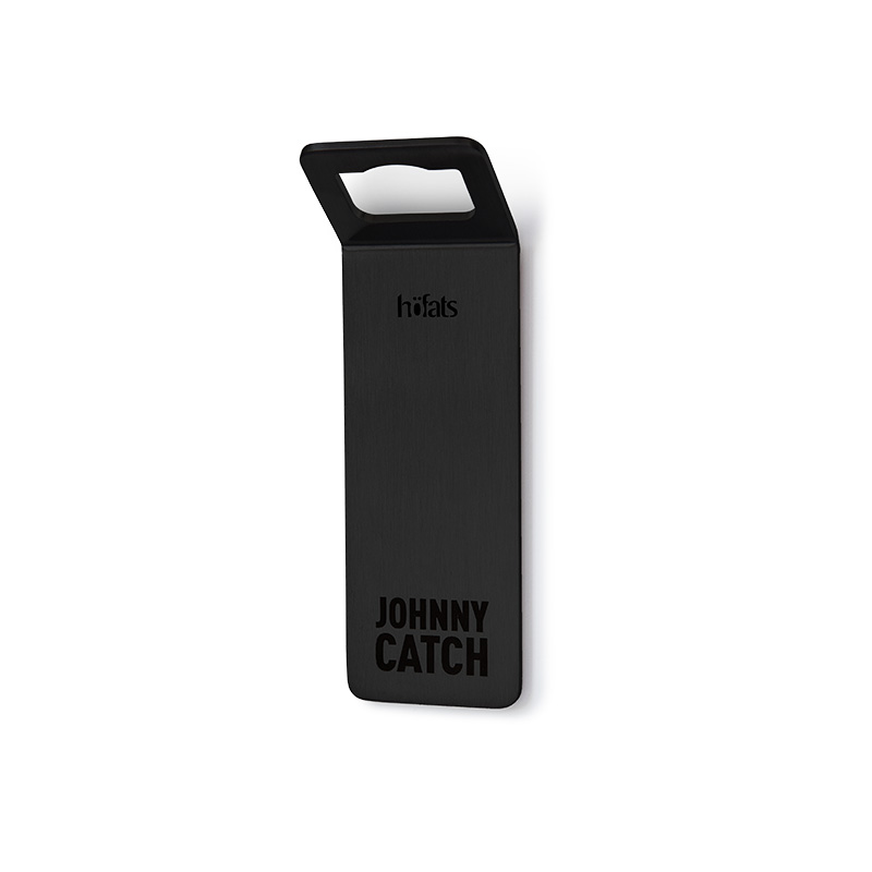 JOHNNY CATCH Magnet Bottle Opener black A black steel piece with the words johnny catch on it, enriched by the presence of the 00841 Johnny Catch Magnet Black Bottleopener, which merges design with utility.