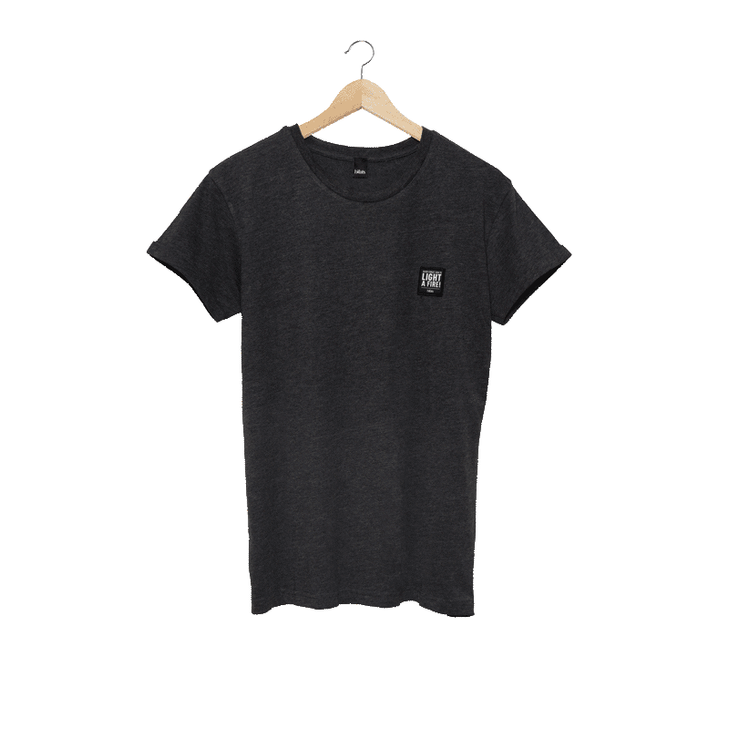 a black t - shirt with a pocket and a small patch on the chest.