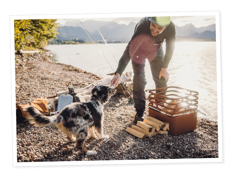 a woman and her dog fishing on a lake.
