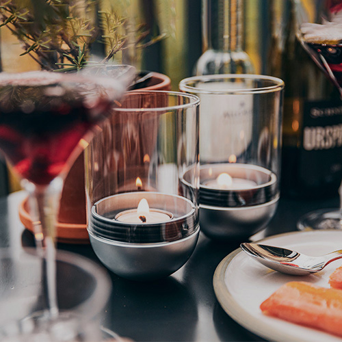 Scene showing a table with a plate of food and wine