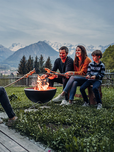 a group of people sitting around a fire pit