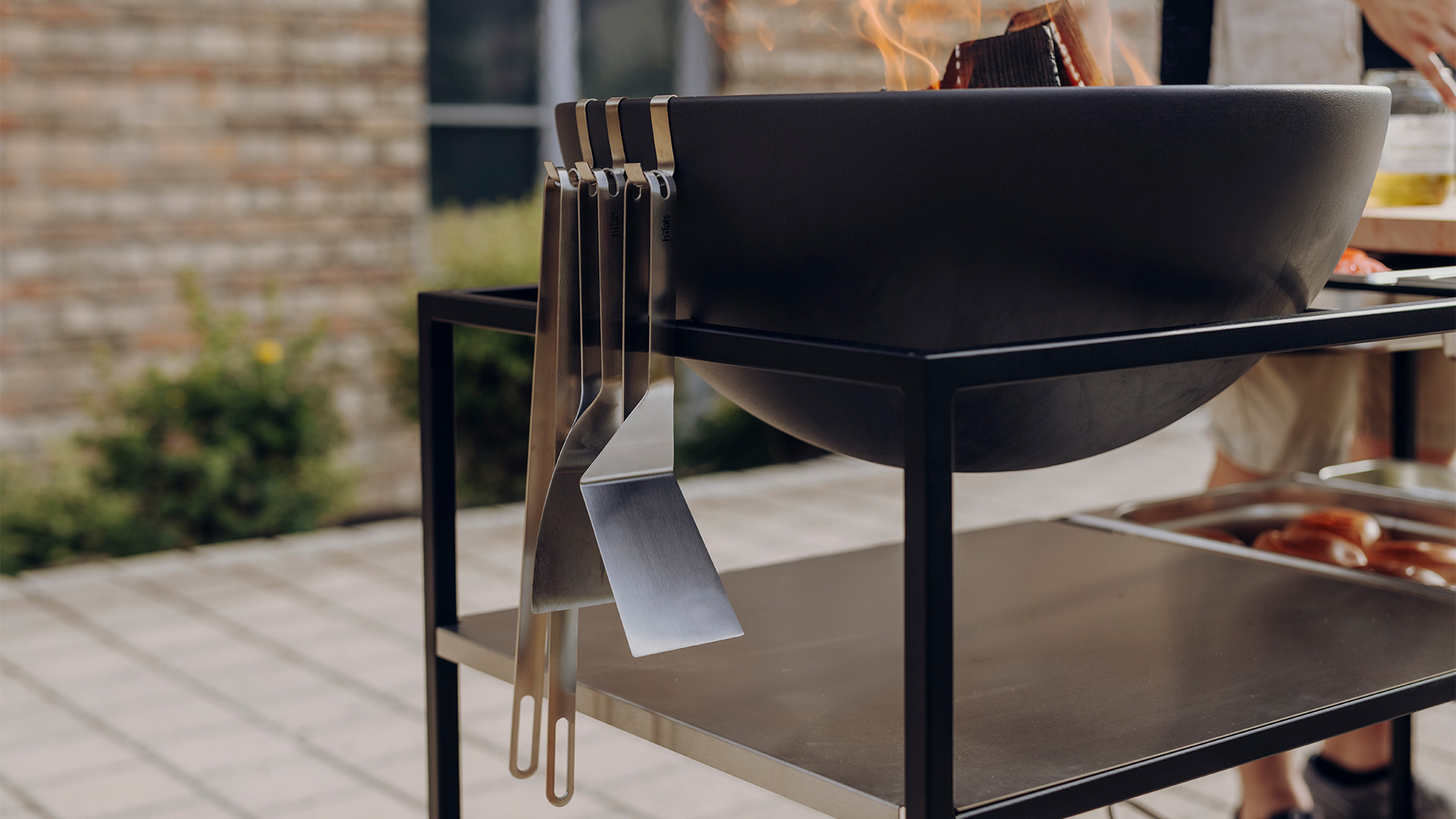 Depicted here is a person is cooking on a grill, with the .