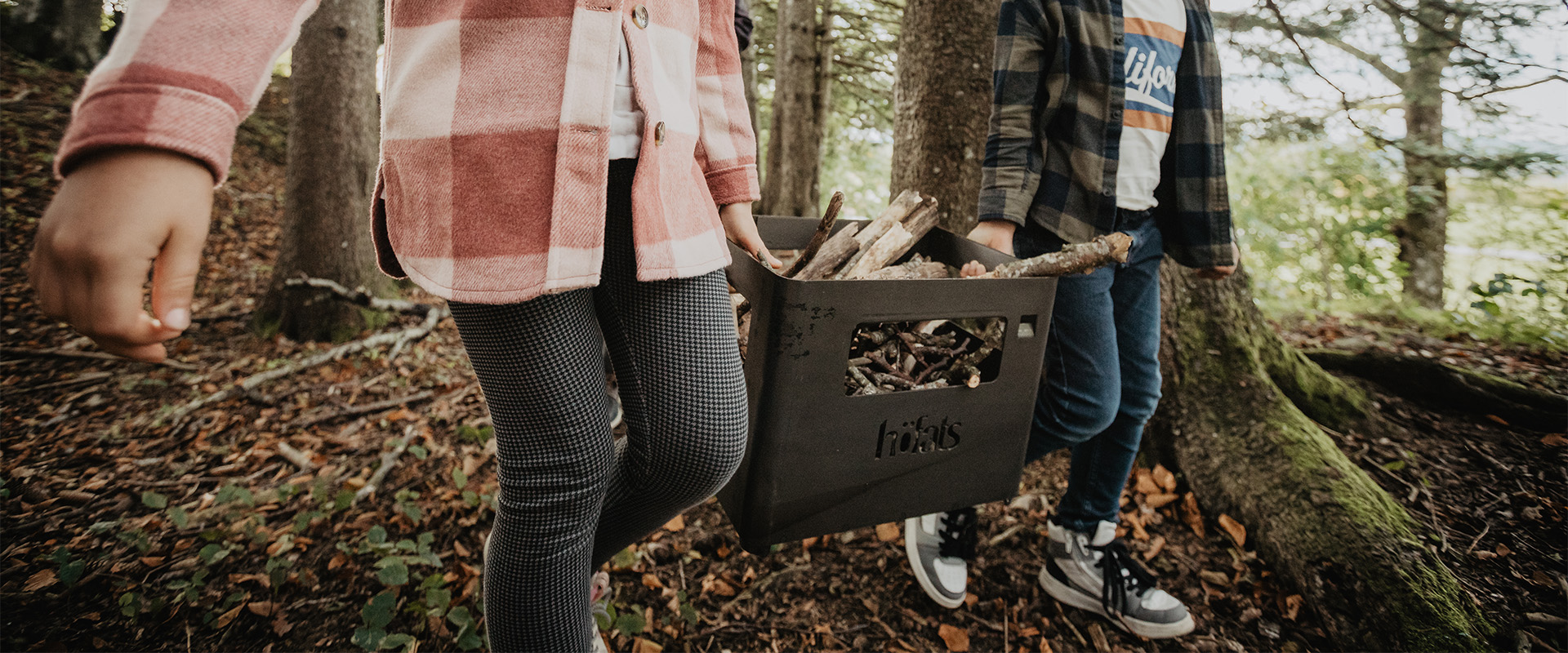 a couple holding a box of firewood