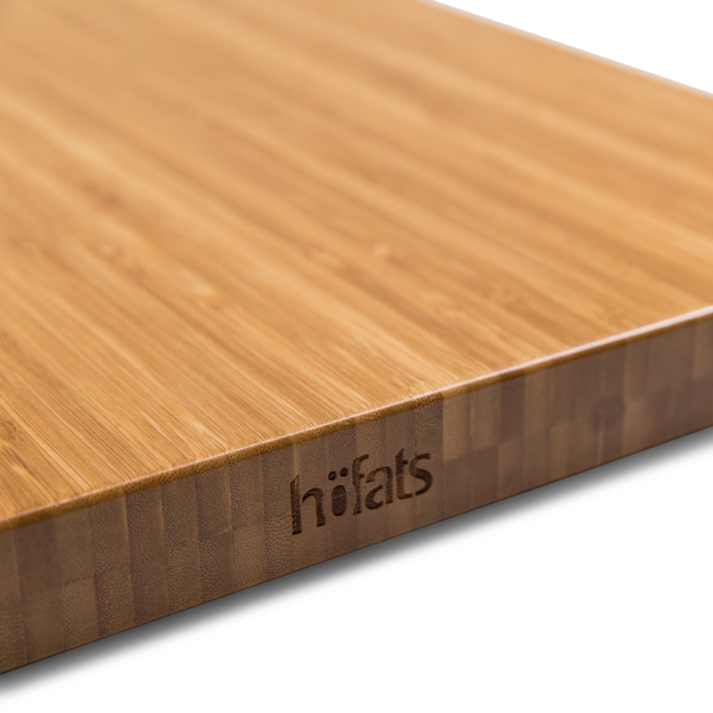 CUBE Board Illustrated is a wooden cutting board with a knife on top, with the CUBE Board.