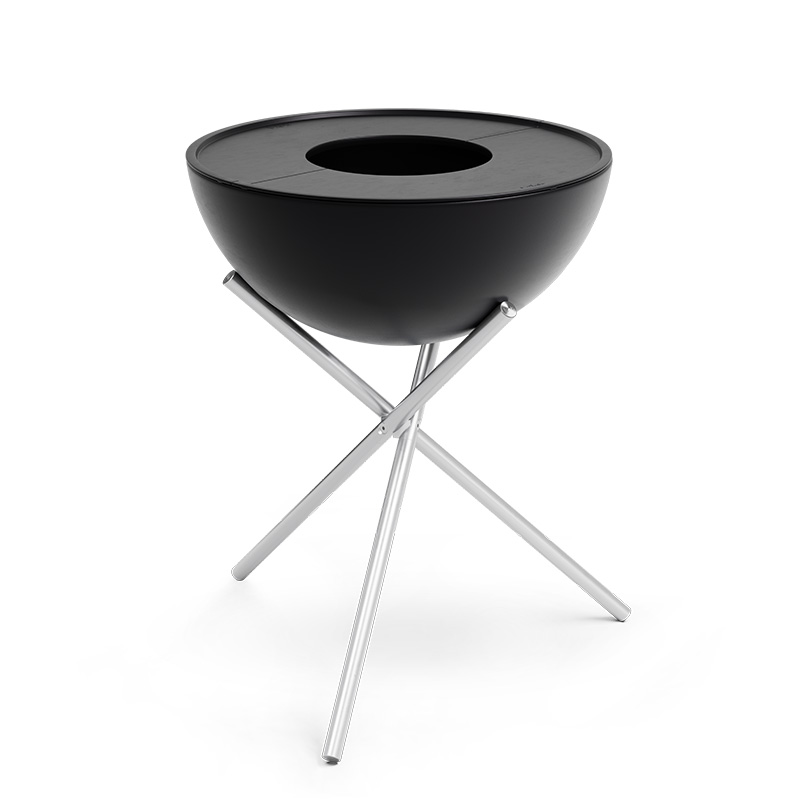 A depiction of a black barbecue grill with a metal stand, featuring the 00263 Bowl 70 Plancha as a central and purposeful element.