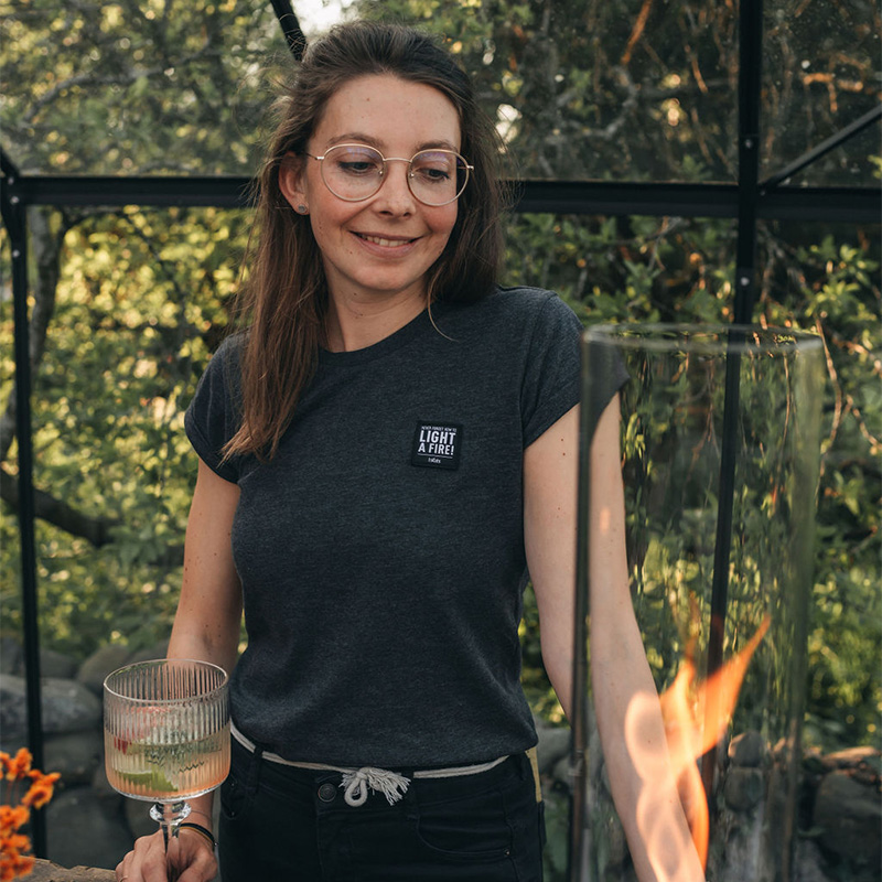 The photo presents a woman holding a glass of wine, with the SHIRT Men grey S.