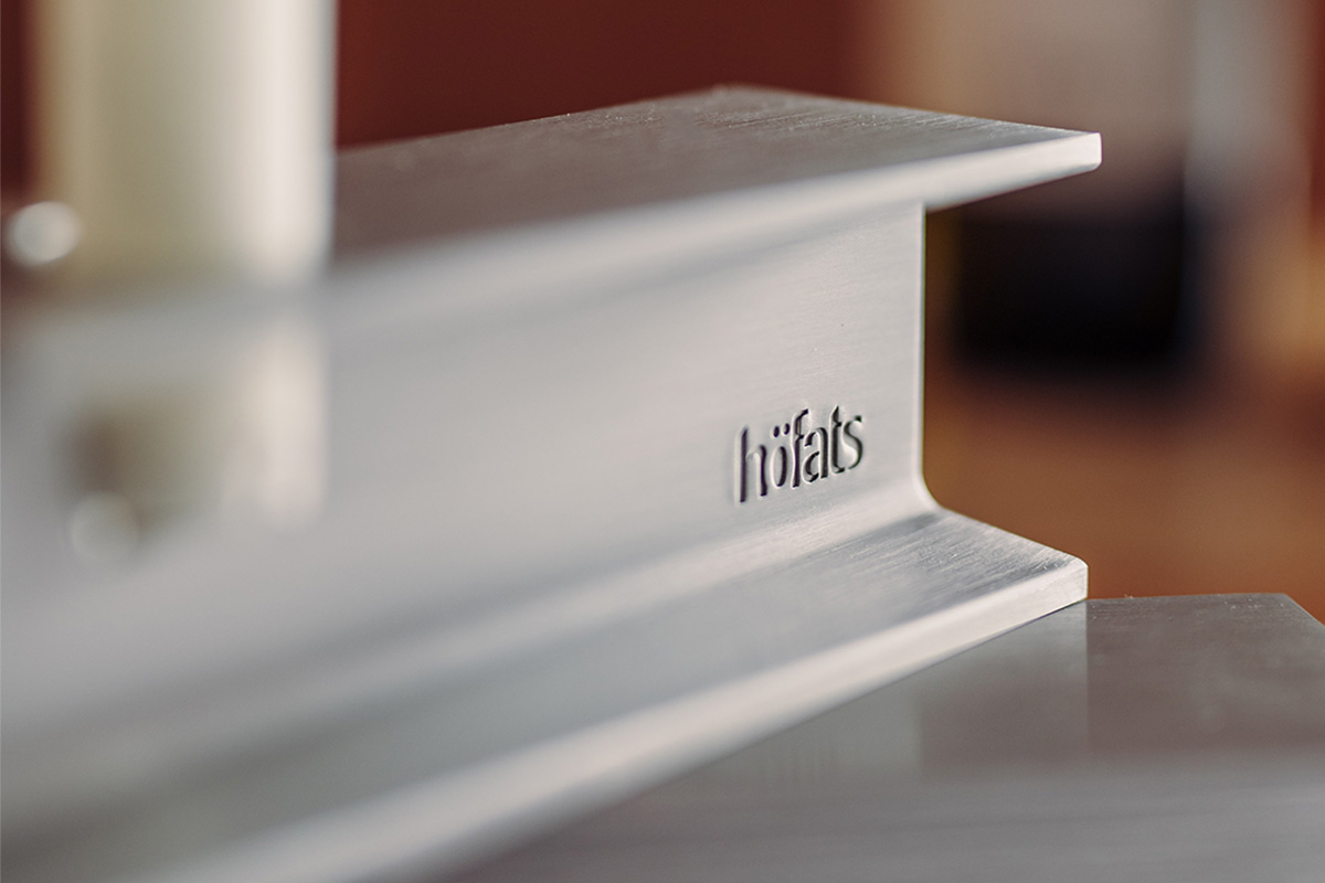 HENRY METAL I Bougeoir argent Cette image montre un gros plan d'une table blanche avec une bougie, avec le bougeoir HENRY METAL I en argent.