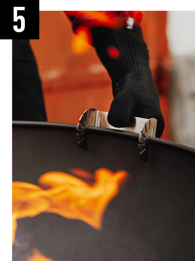 a person holding a black suitcase.