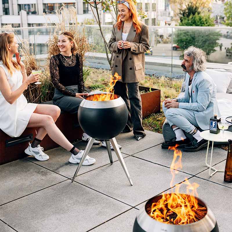 An inviting scene with a group of people sitting around a fire pit, highlighted by the presence of the Moon 45