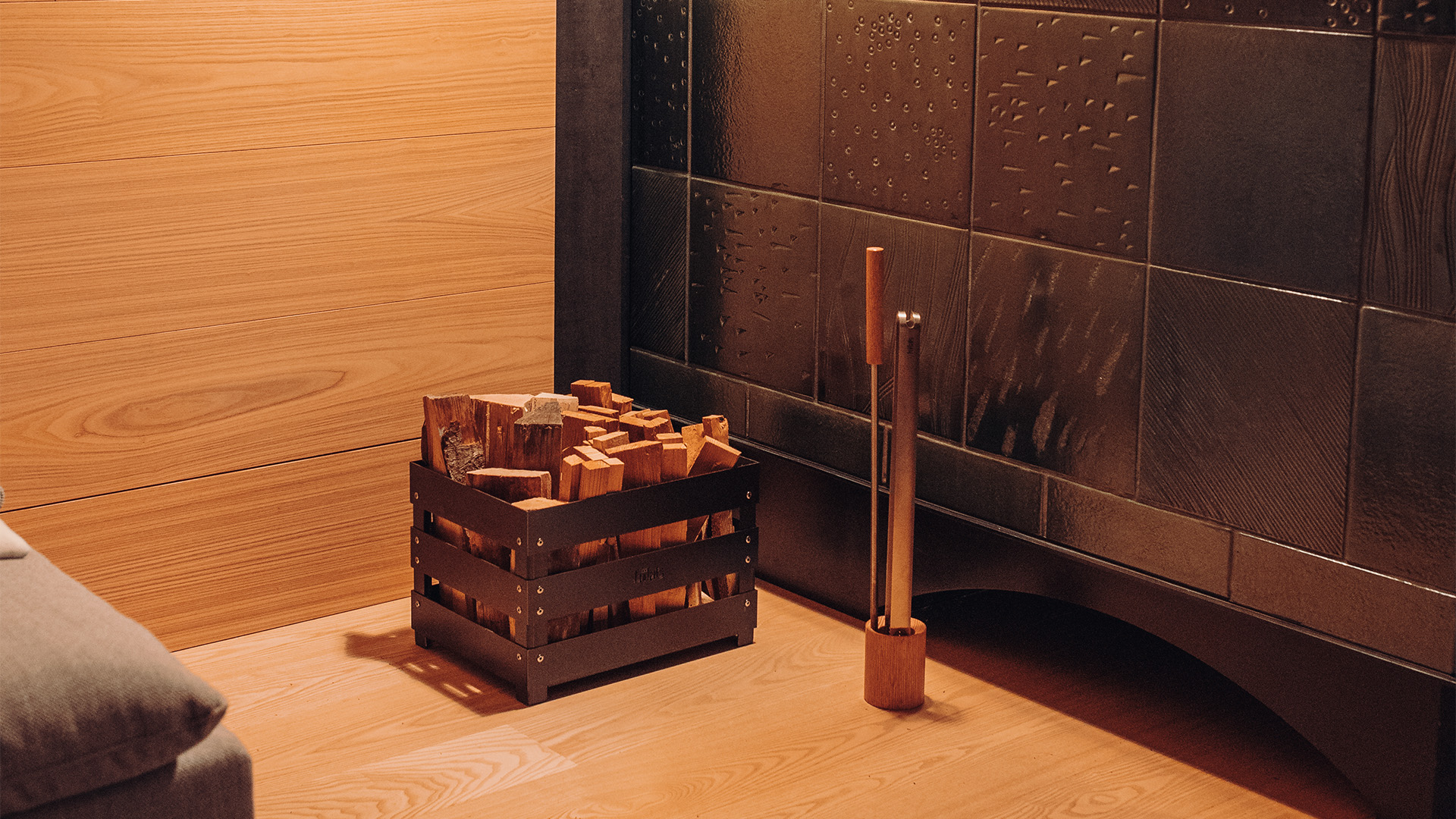 The 00251 Fire Tools Set 3 pcs is shown next to a wooden wall, creating a stylish and accessible visual.