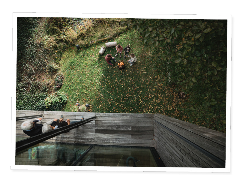 a man and woman sitting on a wooden deck.