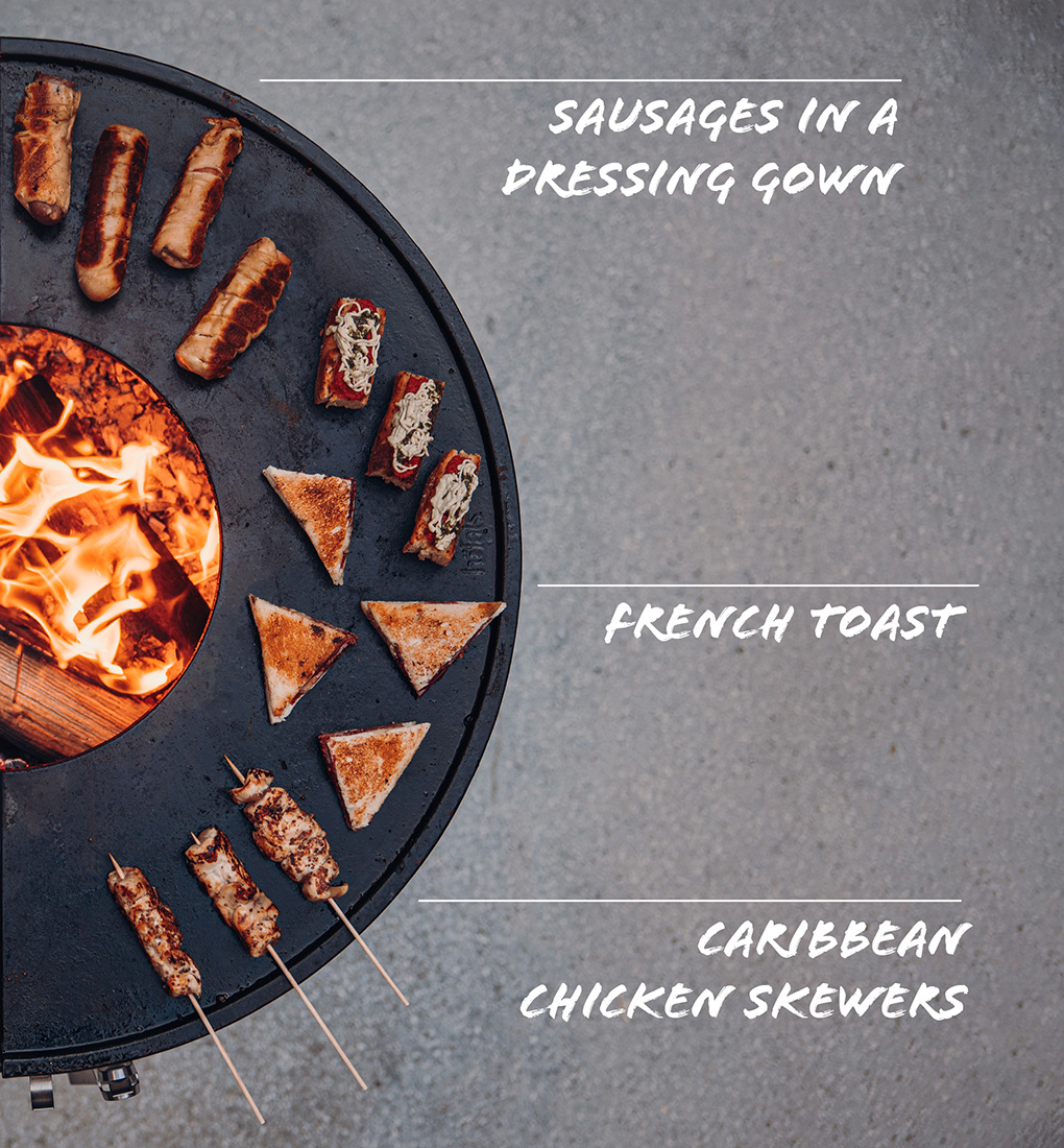 a fire pit with a variety of different types of food