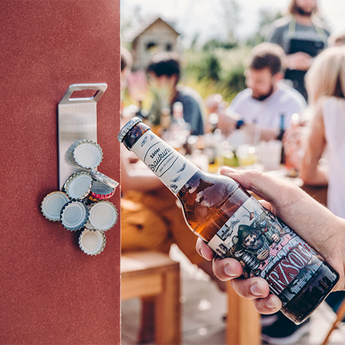 Depicted here is a bottle of beer, with the LOGO SPIN Table-top fireplace.