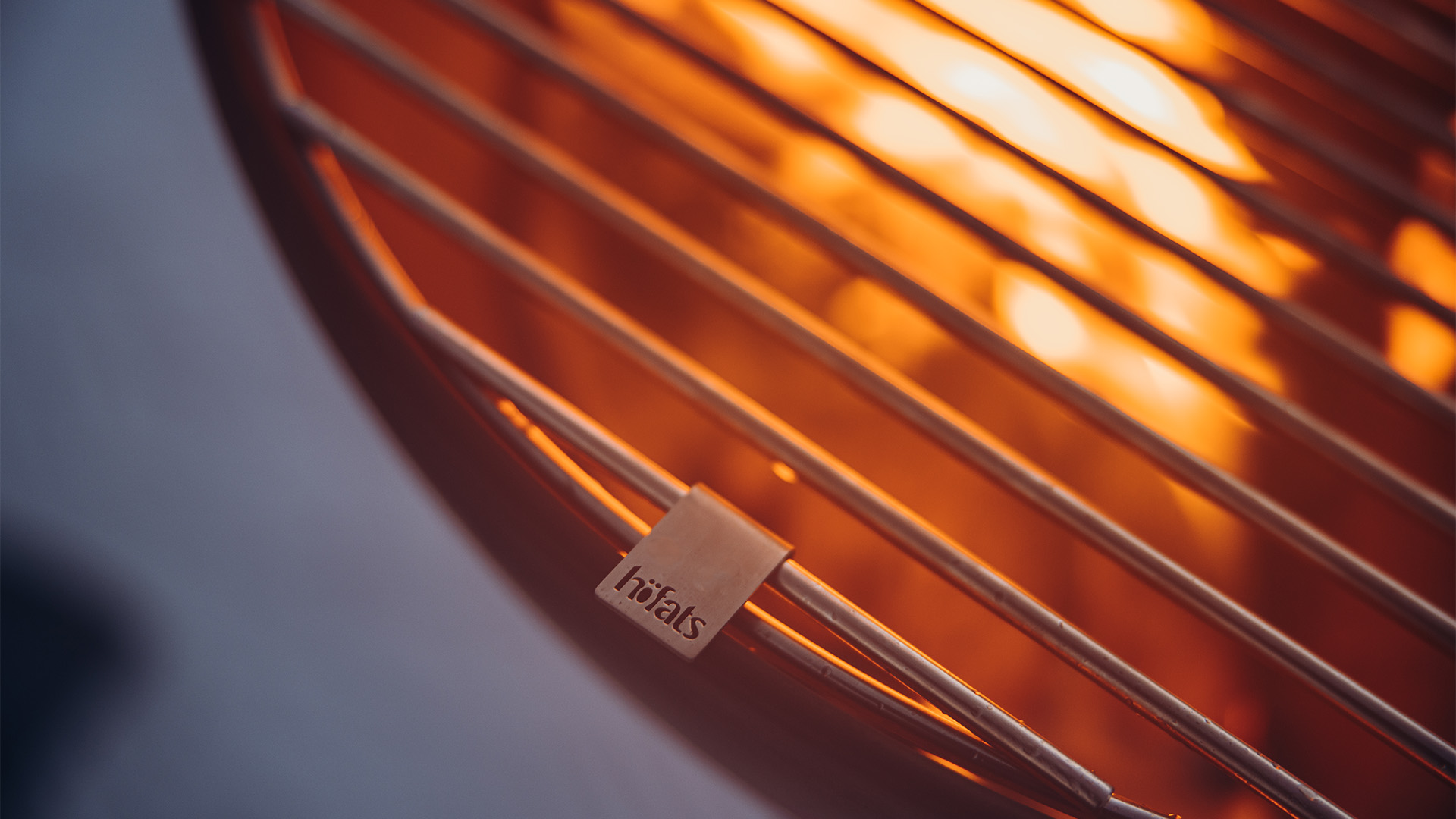 The photo presents a close up of a metal grill with a label on it, with the BOWL 57 Grid.