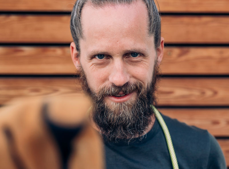 a man with a beard and a dog.