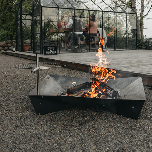 An image showing a fire pit, with the LOGO TRIPLE 90 Firebowl.