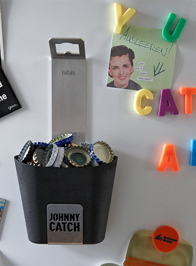 Abgebildet ist ein weißer Kühlschrank mit Magneten und einem JOHNNY CATCH Becher.